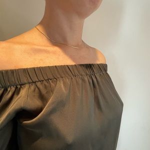 Cute sleeveless top with a light material. Looks like silk.